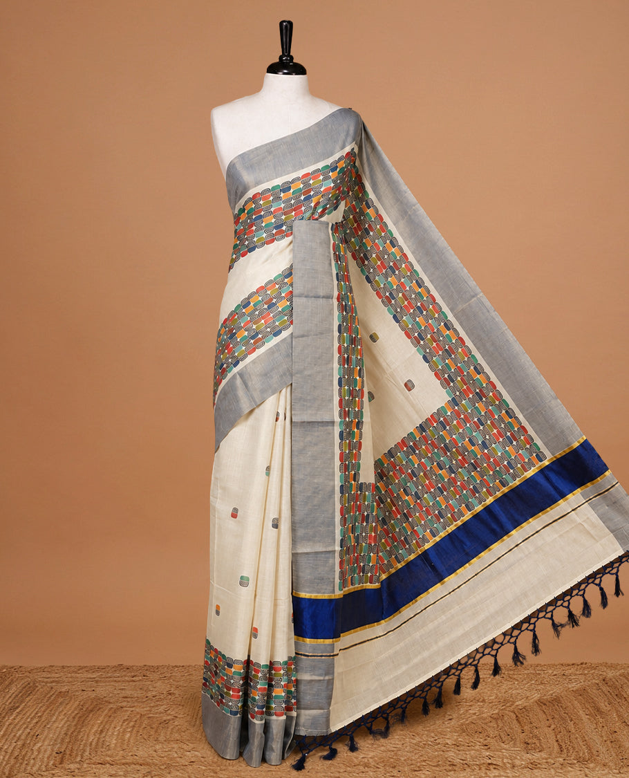 Cream colour Tissue kerala saree featuring Classy Multi colour Box pattern on body, Styled by navy blue & gold zari border and pallu, comes with matching blouse piece.