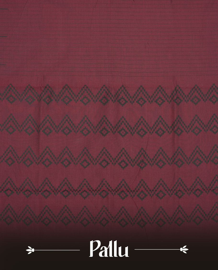 Dark Maroon colour poly cotton saree with black vertical dotted line pattern on the body, paired with a matching pallu featuring black zigzag geometric border, and a coordinated all‑over black stylised fleur‑de‑lis printed blouse piece.