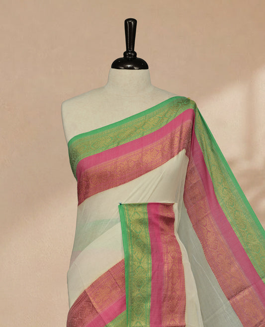 Off white Colour Mul Cotton saree featuring Elegant plain body, contrast Green & Pink colour with gold zari traditional border.