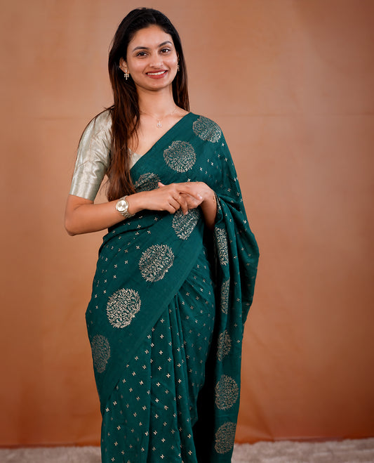 Teal Green colour vijithra silk saree featuring small zari details on body, Tree design border.