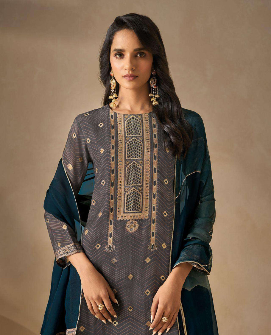 Cool Gray colour suit material with silk jacquard digital print top with embroidery highlighted sleeve work, paired with matching satin bottom and a contrast lightweight printed dupatta.
