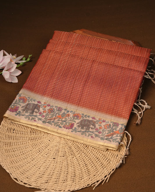 Brown colour tussar saree featuring golden zari dot stripped pattern on the body, complemented by a contrast cream colour mutlicolour floral kodi & animal print on border & pallu, paired with a matching blouse.
