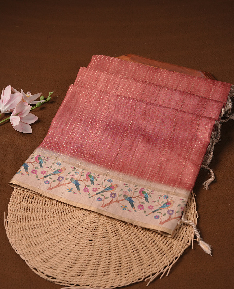 Peach colour tussar saree featuring golden zari dot stripped pattern on the body, complemented by a contrast cream colour mutlicolour floral kodi & animal print on border & pallu, paired with a matching blouse.