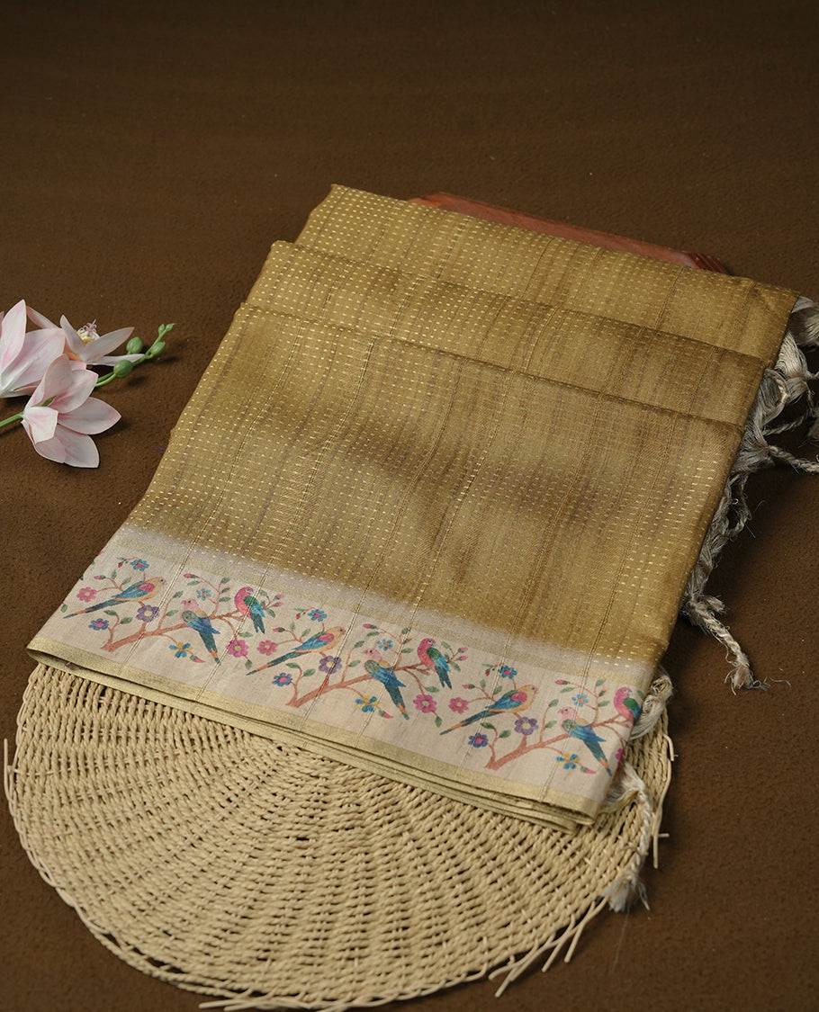 Olive colour tussar saree featuring golden zari dot stripped pattern on the body, complemented by a contrast cream colour mutlicolour floral kodi & animal print on border & pallu, paired with a matching blouse.