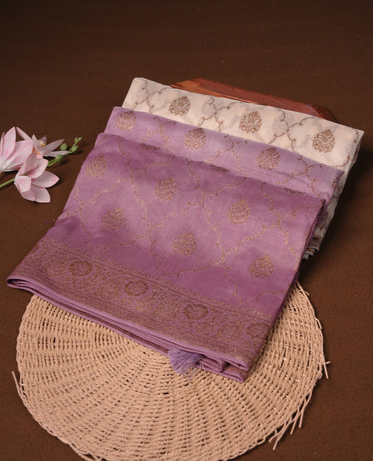 Cream colour semi tussar Banarasi saree featuring Antique zari motifs on body, paired by contrast onion pink colour border, and a matching blouse piece.