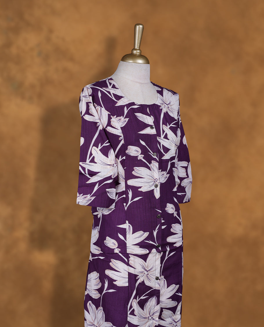 Purple colour kurti adorned with White floral prints, featuring a round neckline with button placket and comfy 3/4th sleeves.