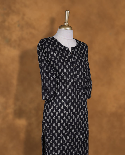 Black colour kurti adorned with cream floral prints, featuring a round neckline with button placket and comfy 3/4th sleeves.