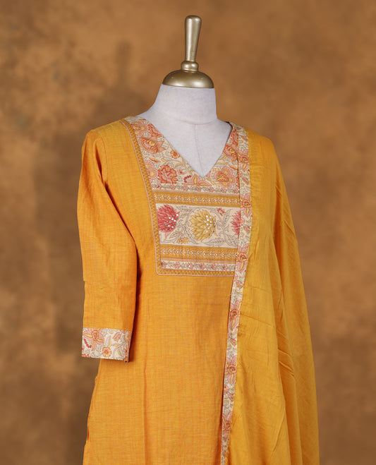 Yellow colour churidar set featuring tiny stone on V neckline, sleeves, and plain the body, Paired with a matching dupatta