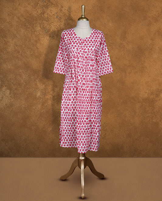 White colour Kurti featuring  pink floral print pattern across,  round neckline with botton detail, and sleeves,