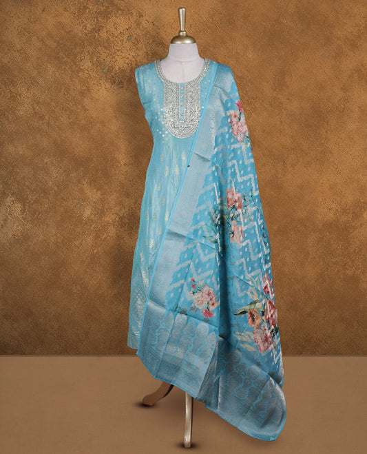 Aquamarine blue colour churidar set featuring round neckline, sleeveless pattern, and heavy sequin-embellished yoke with woven butti motifs on body, paired with a matching jacquard floral printed dupatta.