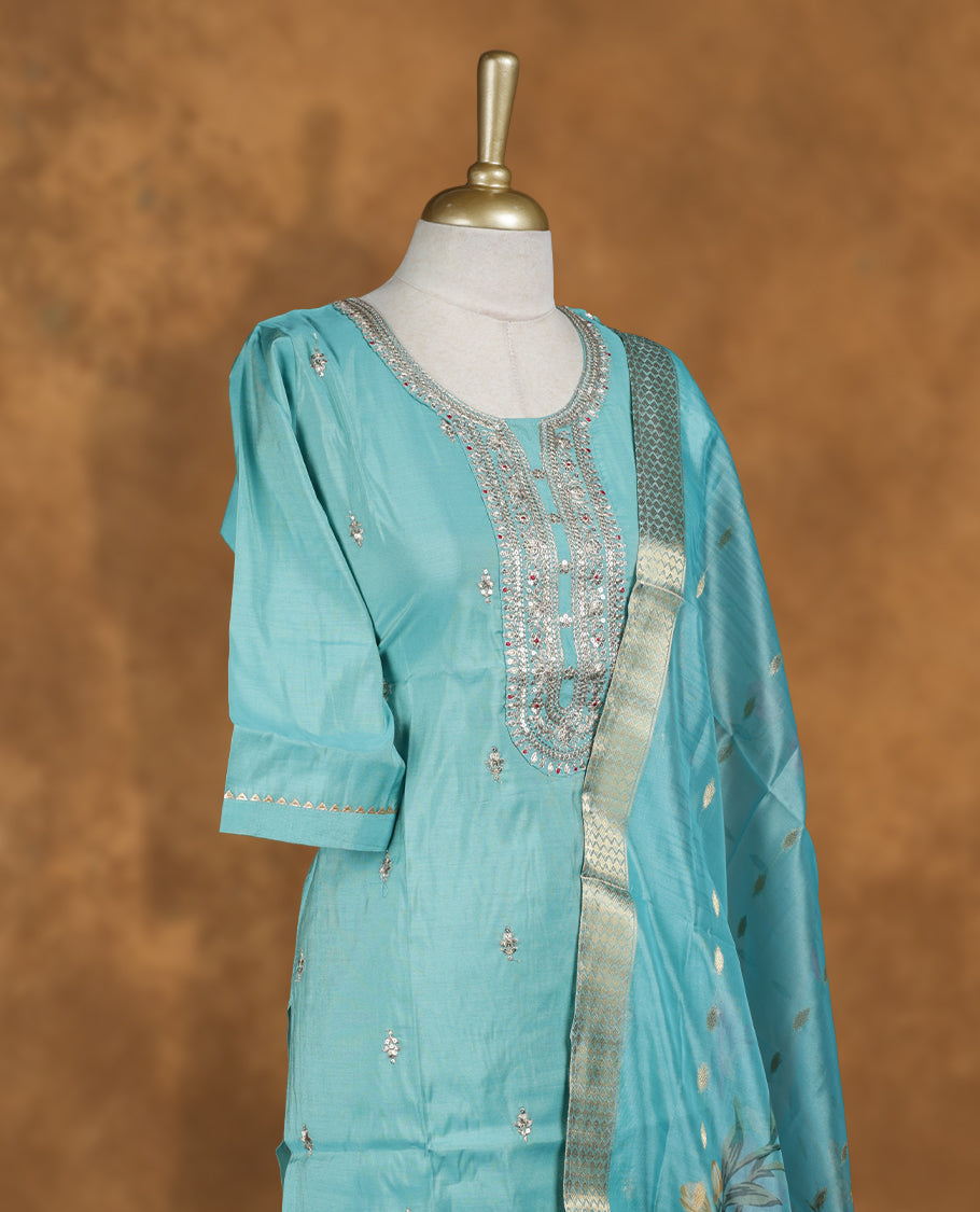 Aqua blue colour churidar set featuring thread and cut beats embroidered neckline, sleeves, and Gold colour motifs on body , Paired with a matching dupatta