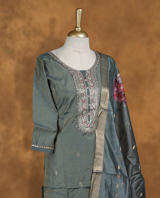 Olive green colour churidar set featuring thread and cut beats embroidered neckline, sleeves, and Gold colour motifs on body , Paired with a matching dupatta