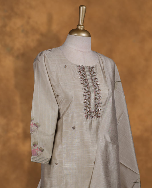 Beige colour churidar set featuring thread and cut beats embroidered neckline, sleeves, and Plain body with floral pattern on border , Paired with a matching dupatta