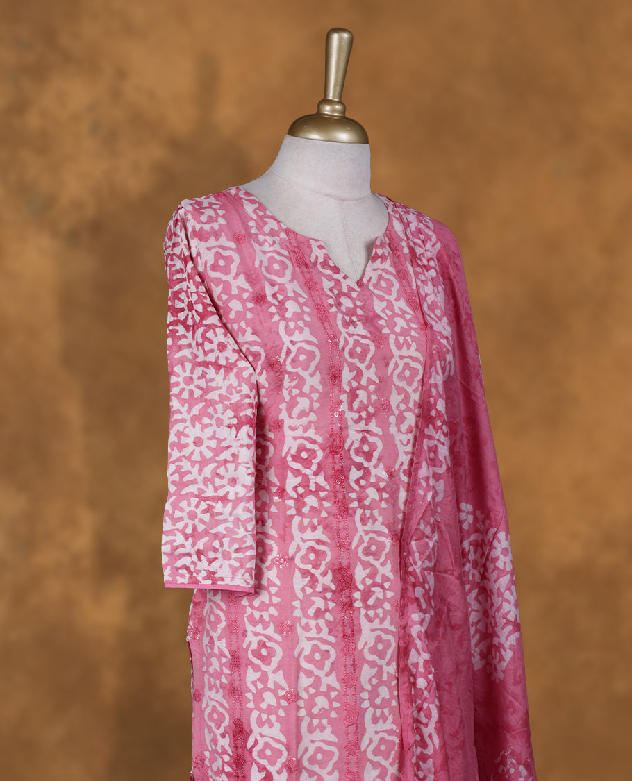 Pink and white colour churidar set featuring V neckline, sleeves, and White floral pattern across the body, Paired with a matching dupatta