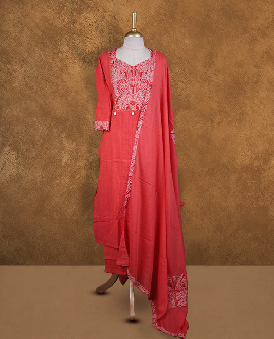 Coral pink churidar set with V neckline, three‑fourth sleeves, paisley printed yoke and matching border detailed dupatta.