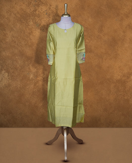 Pistachio green solid kurti featuring a round neckline with a subtle keyhole detail, a straight calf-length silhouette, and three-quarter sleeves highlighted with delicate floral embroidery.