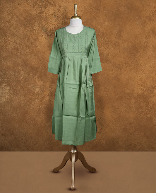 Pastel green colour kurti with styled with a stone pattern around neckline, knee length design, and a sleeve .