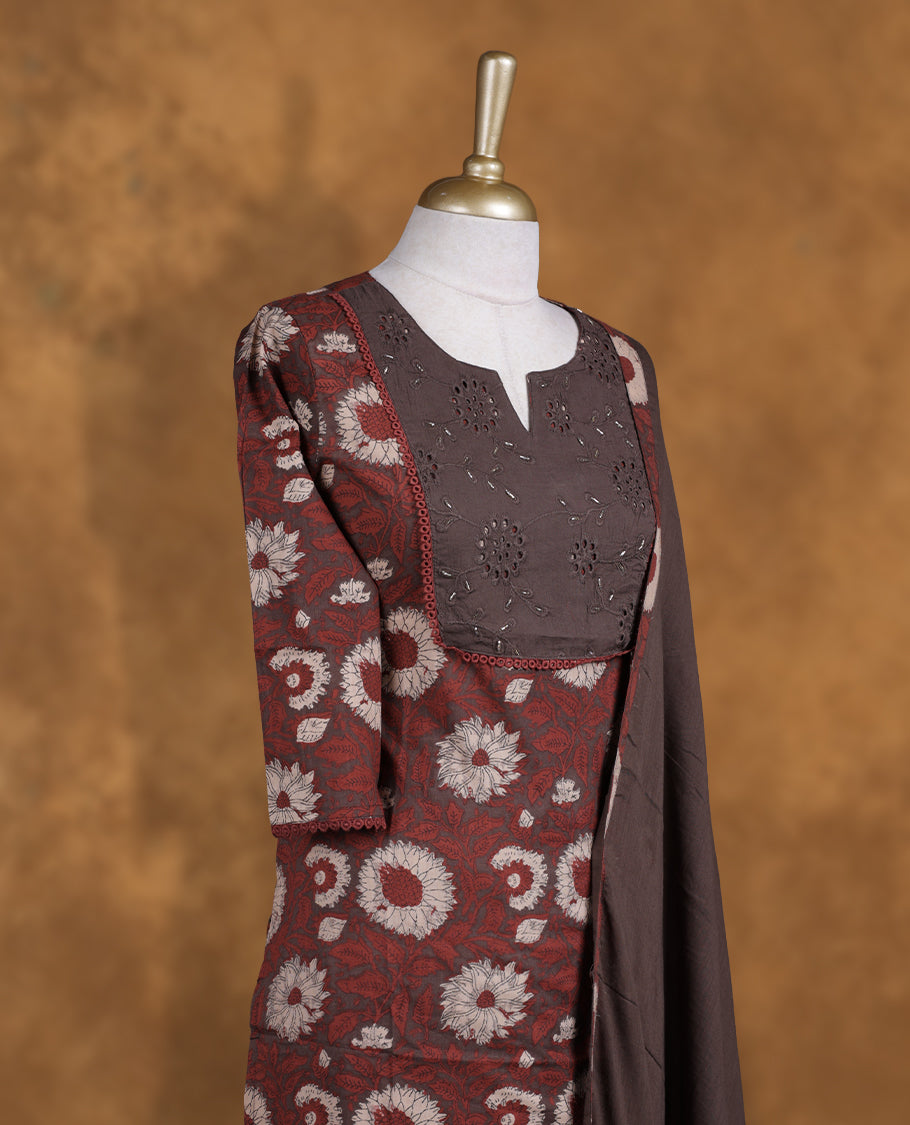 Dark brown colour churidar set featuring elegant Light gold cut beat embroidery on the neckline, sleeves, and floral pattern across the body, Paired with a matching dupatta