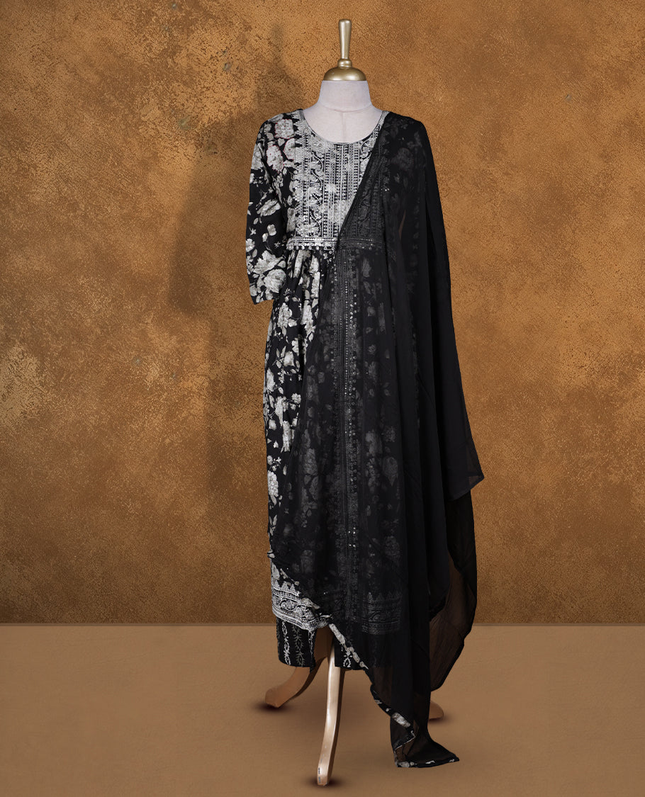 Black colour churidar set featuring thread embroidered pattern neckline, sleeves, and floral print across body , Paired with a matching dupatta