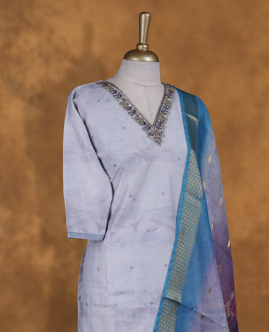 Light Lavender colour churidar set featuring thread and cut beats embroidered neckline, sleeves, and Gold colour motifs on body , Paired with a matching dupatta