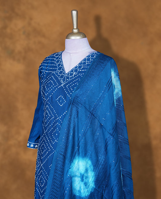 Blue colour churidar set featuring white pattern across body and v neckline, with matching bottom and dupatta.
