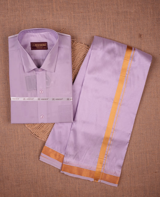 Violet colour shirt and dhoti with gold colour border, paired with matching colour silk saree featuring gold zari buttas and traditional border paired with matching blouse piece.