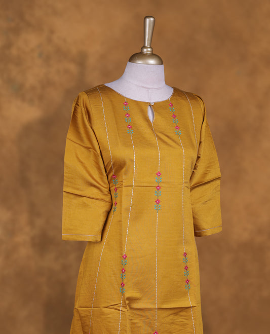 Mustard colour kurti with styled with a thread pattern around neckline & across body, knee length design, and a sleeve .