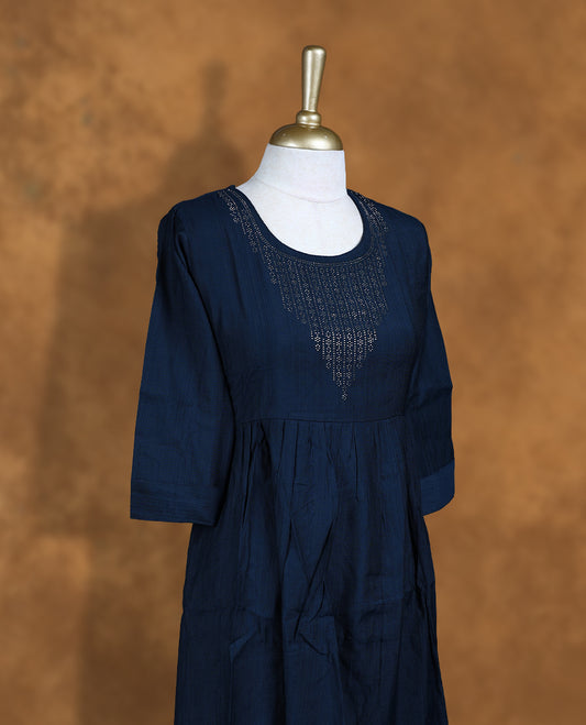 Dark blue colour Kurti featuring a round neckline with white stone detail, and sleeves.