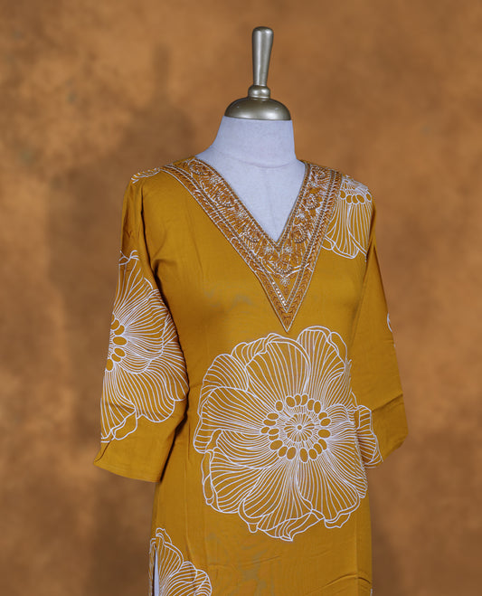 Yellow colour kurti with styled with a thread & beats pattern around neckline & white pattern across body, knee length design, and a sleeve .