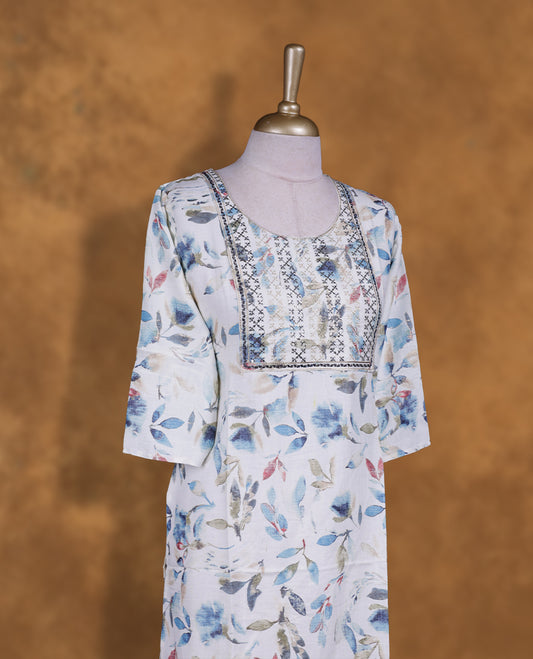 White colour kurti with styled with a thread pattern around neckline, print pattern across body, knee length design, and a sleeve .