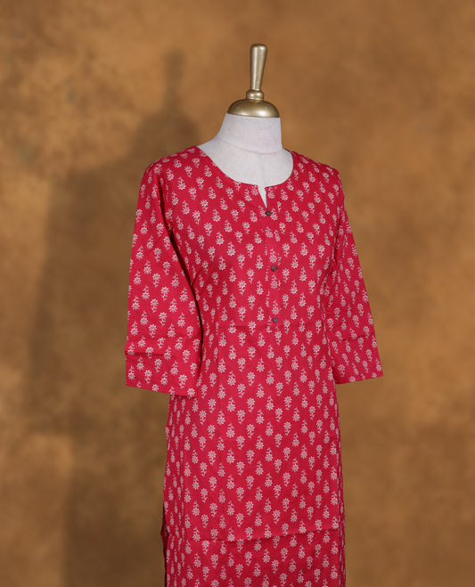 Rani pink colour Kurti featuring floral print pattern across,  round neckline with split, and sleeves,