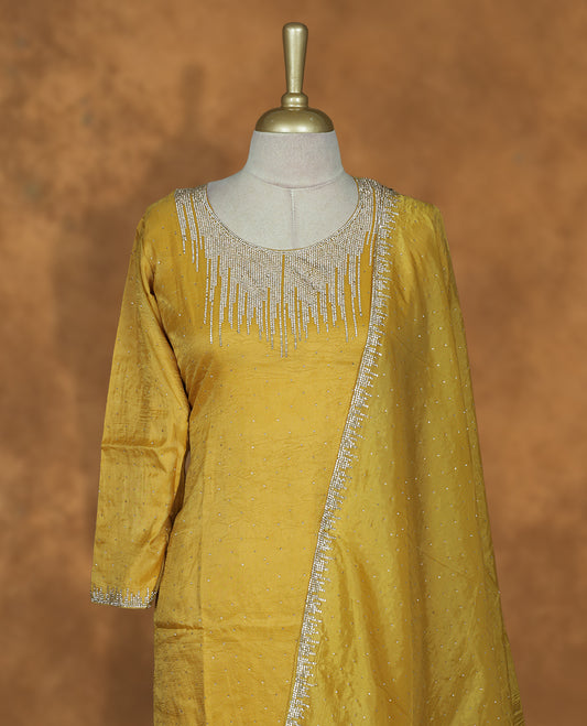 Yellow colour sharara set featuring gold colour stone worked on neckline, sleeves, and Stone scattered on body , Paired with a matching dupatta