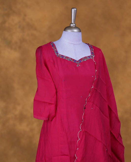 Red colour churidar set featuring a richly embellished sweetheart neckline with contrast thread and sequin detailing, paired with a matching ruffled dupatta.