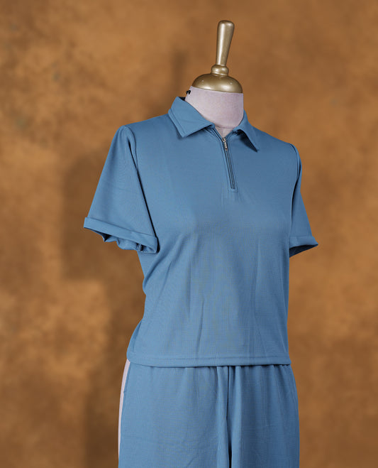 Teal colour coord set styled with a T shirt design with zip detailed & collar , short sleeve, pair a matching bottom pant .