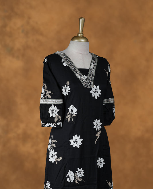 Black colour floral printed kurti featuring a V-neckline accented with thread-pattern detailing, a knee-length silhouette, and three-quarter sleeves