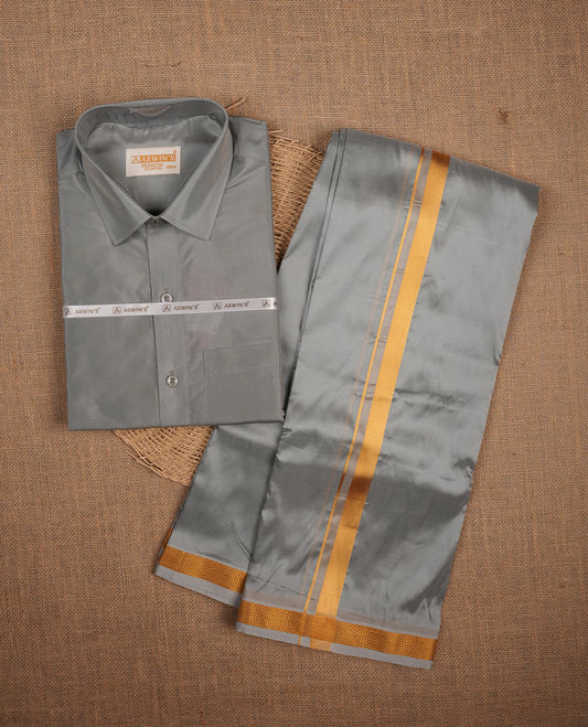 Grey colour shirt and dhoti with gold colour border, paired with matching colour silk saree featuring gold zari buttas and traditional border paired with matching blouse piece.