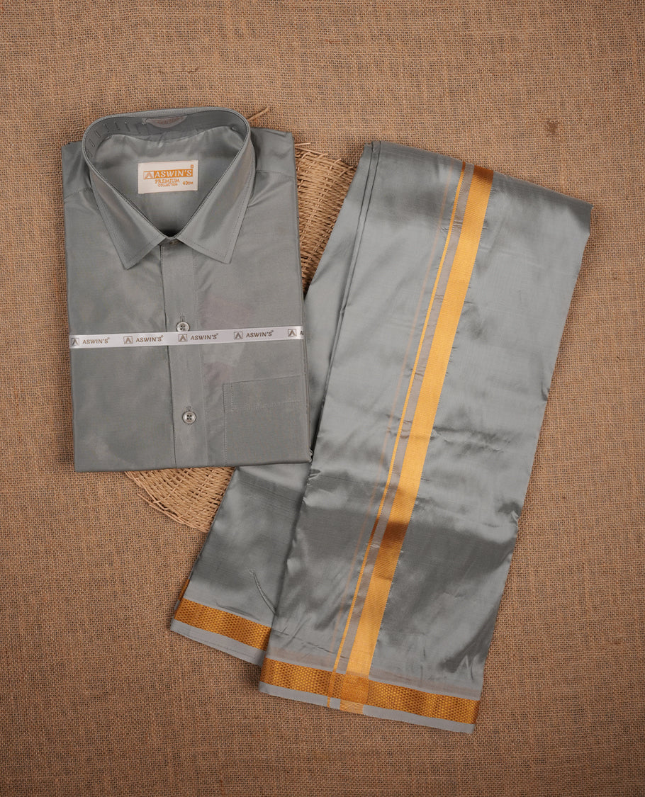 Grey colour shirt and dhoti with gold colour border, paired with matching colour silk saree featuring gold zari buttas and traditional border paired with matching blouse piece.