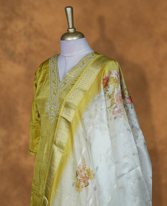 Lemon colour churidar set featuring beats and thread embroidery on v neckline and matching dupatta and pant.