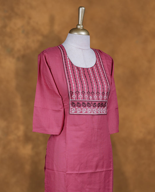 Burgundy rose colour kurti with styled with a thread pattern around neckline, fknee length design, and a sleeve