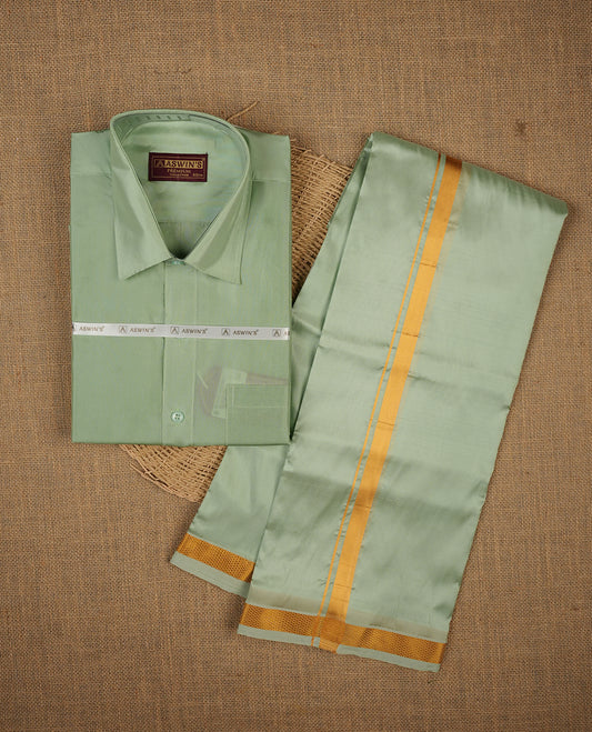 Pista colour shirt and dhoti with gold colour border, paired with matching colour silk saree featuring gold zari buttas and traditional border paired with matching blouse piece.