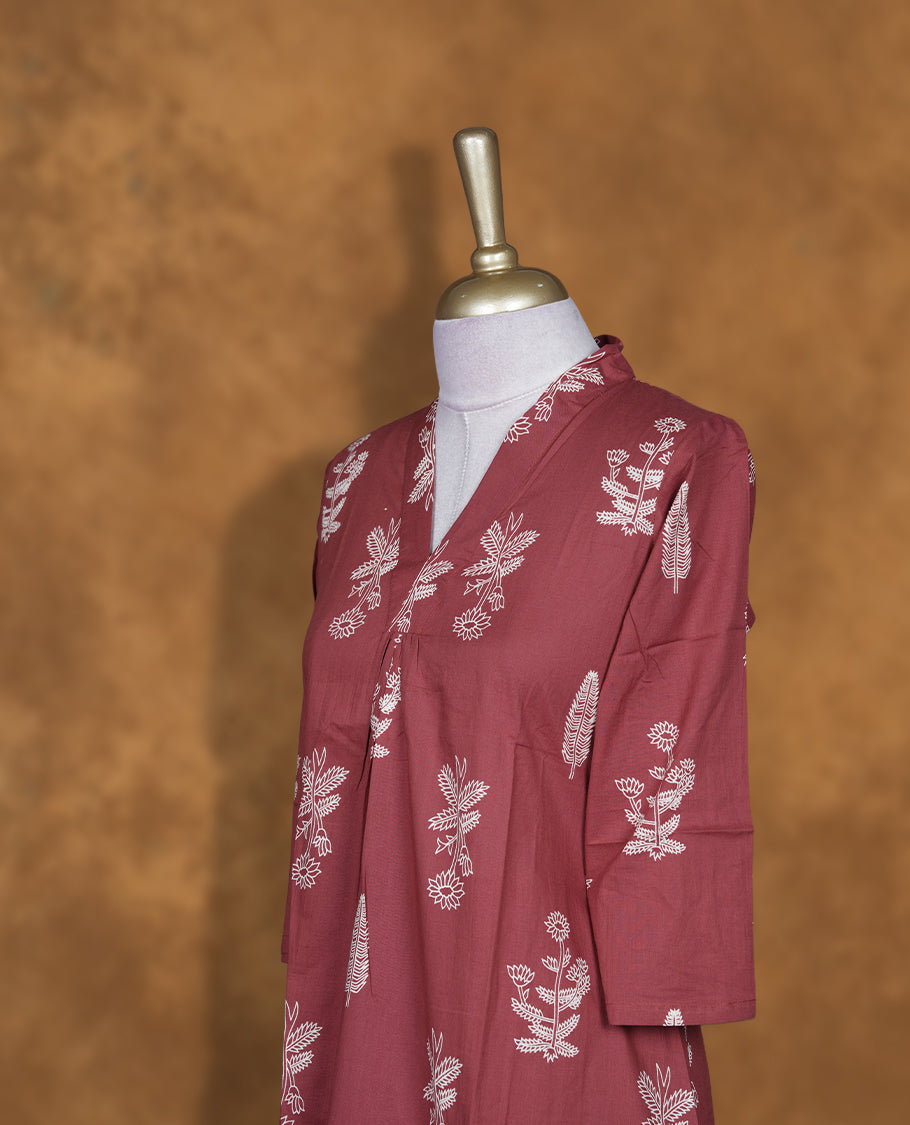 Brown colour kurta set featuring an elegant V-neckline, all-over white floral motifs, three-quarter sleeves, and a straight-fit kurta paired with a matching bottom for effortless everyday style.