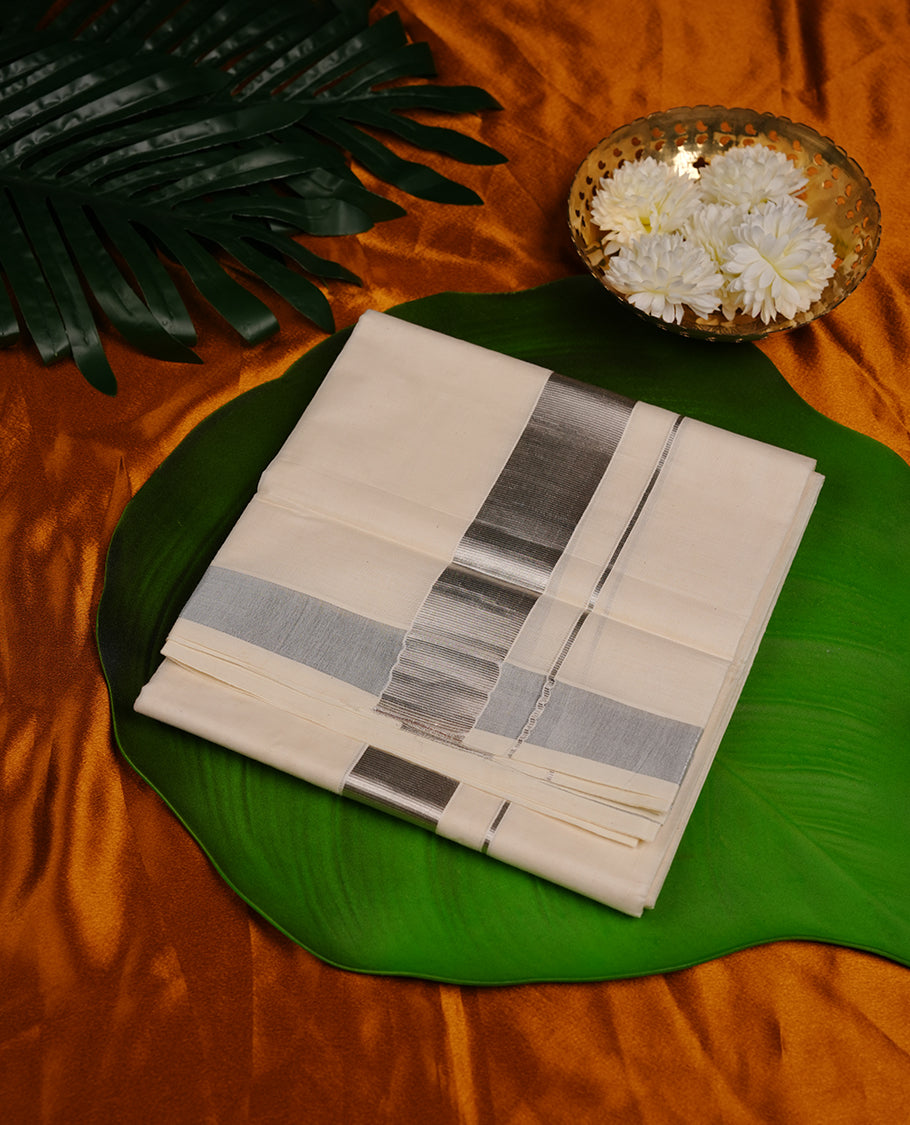 Cream colour cotton double dhoti featuring 2 inch silver kasavu zari border