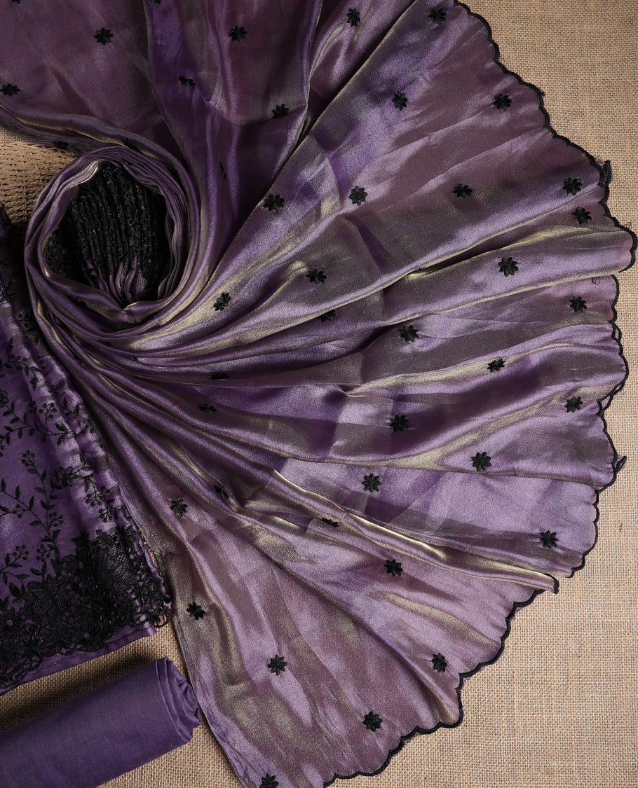 Rich lavender colour dual shaded suit material with delicate black floral embroidery and lace border & Includes matching dupatta with embroidered motifs and plain bottom fabric.