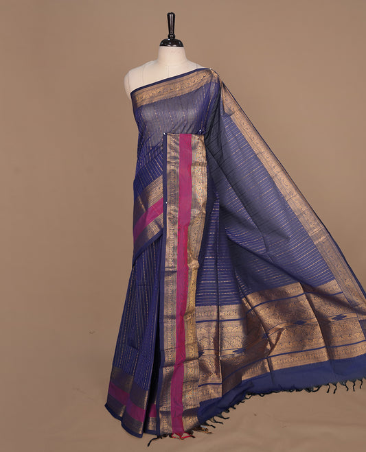 Navy blue colour chettinad cotton saree featuring gold zari stripes on body, complemented by magenta with gold zari border, paired with matching blouse piece.