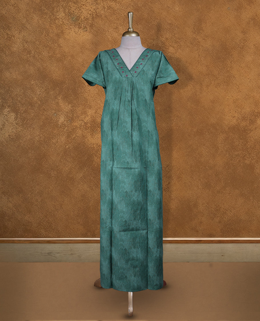 Aqua green colour NStyle nighty featuring dark green patterns, a V-neckline with thread detailing, short sleeves, and a full ankle-length design.