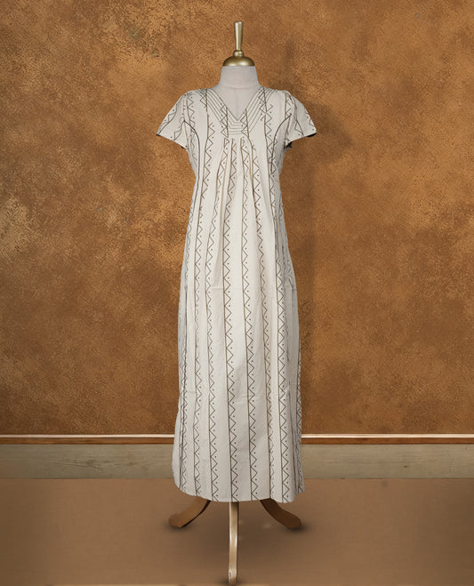 Cream colour NStyle nighty featuring dark green geometric patterns, a V-neckline with thread detailing, short sleeves, and a full ankle-length design.