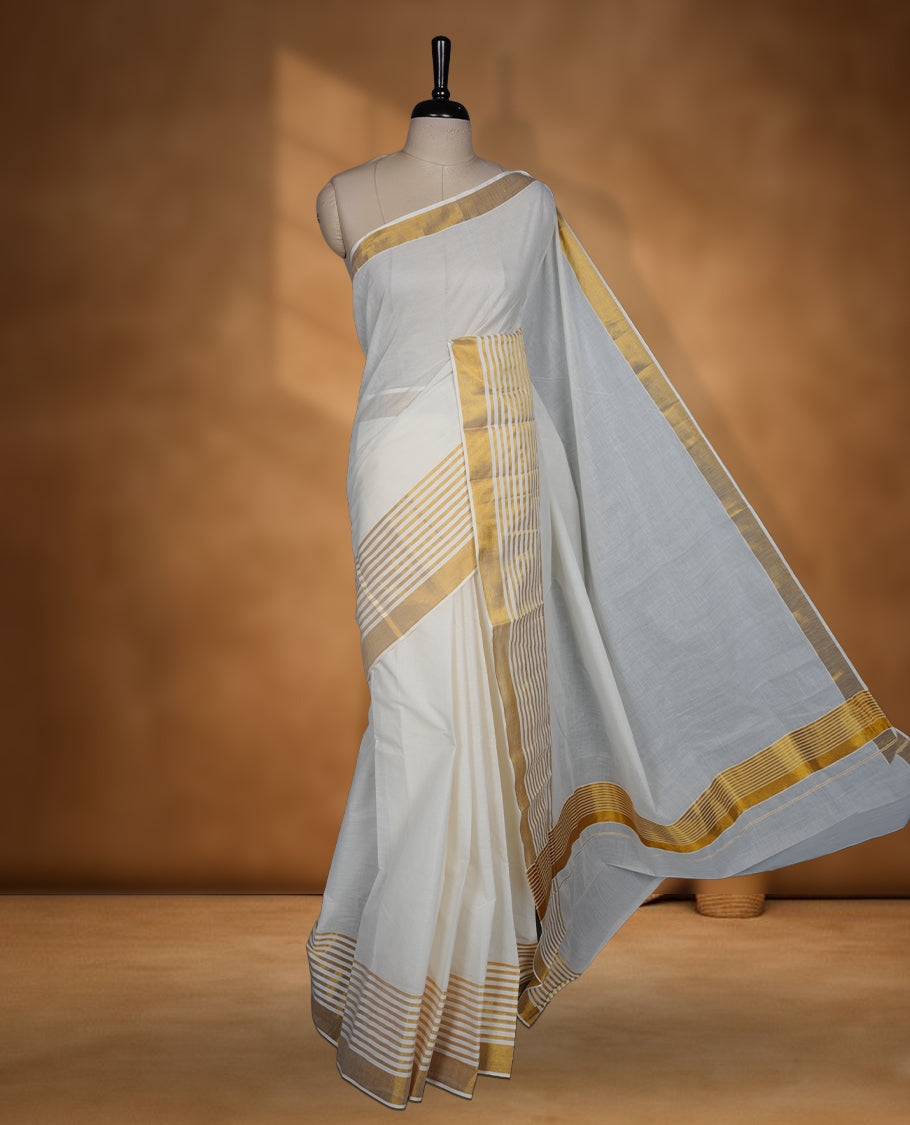 Off white cotton Kerala saree with a plain body, striped golden zari border, and traditional pallu, paired with a matching blouse.