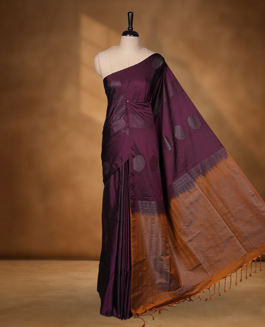 Deep plum colour soft silk saree featuring Antique zari motifs on body with Highlighting contrast Mustard colour pallu and paired with matching blouse piece.