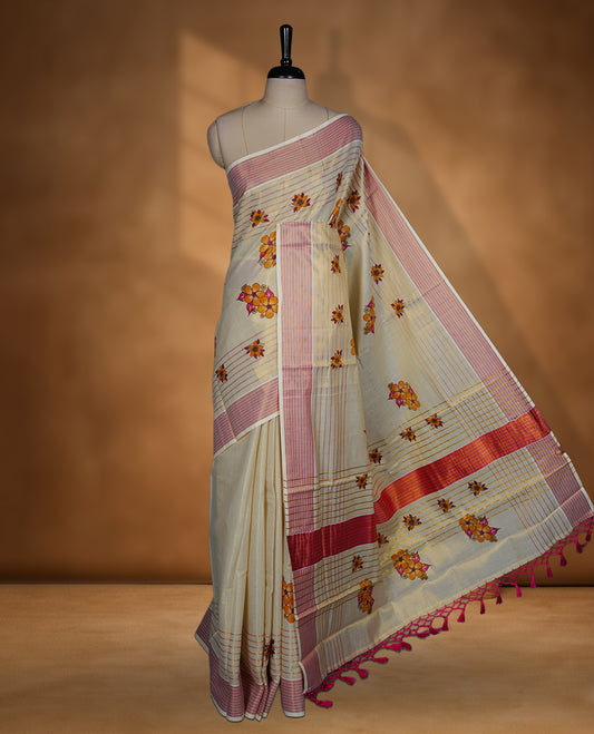 Light gold colour Tissue Kerala saree featuring a Plain body, an intricately woven gold and pink traditional border with floral print paired with a matching blouse.