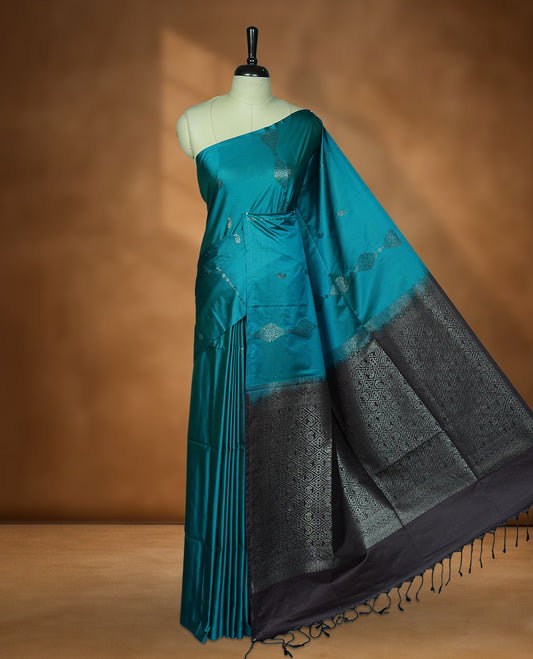 Aqua green colour soft silk saree featuring Antique zari motifs on body with Highlighting contrast Dark purple colour pallu and paired with matching blouse piece.